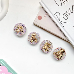 Set of four luxury rhinestone bear and bow phone socket grips with gold metallic finish