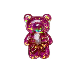 Glittery purple bear phone grip with gold bow detail and iridescent sequins