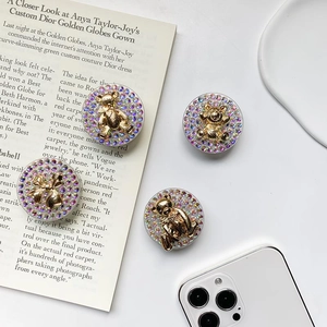 Detail of rhinestone bear phone socket grip featuring sparkling crystal stones on round base