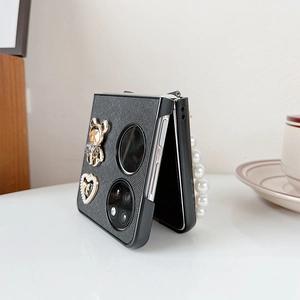 Detail view of foldable phone case with litchi leather texture and pearl handle strap