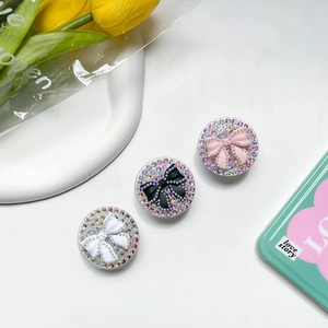 Sparkly rhinestone phone grip set with decorative bows for secure mobile support