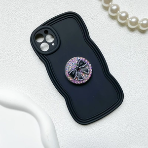 Detail of wavy phone case with sparkling rhinestone bow grip for iPhone Pro models