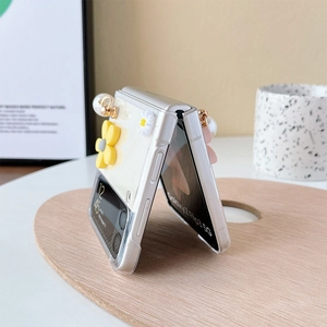Detail showing transparent folding phone case with daisy flowers and pearl strap handle