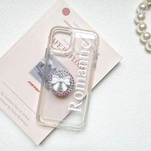 Romantic phone case with rhinestone pearl bow grip on a French-style book background