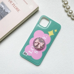 Detail of mint green phone case with love story text and rhinestone bow grip holder