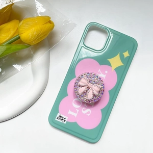 Detail of mint green phone case with pink rhinestone bow grip and flower design