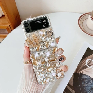 Detail of luxury rhinestone bow and crown accessories on a transparent phone case