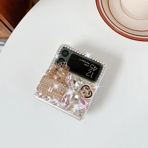 Macro view of luxurious rhinestone bow case for Samsung Z Flip with gold chain detail