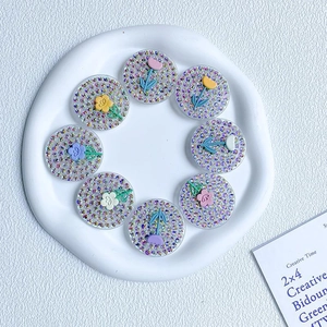 Set of 8 glittery flower phone grips in pastel colors on a minimal white tray