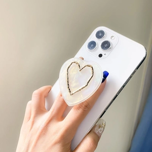 Minimalist pearl texture heart phone grip and expandable stand on white smartphone