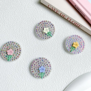 Glittery rhinestone phone grip set with tulip flowers on a textured white background