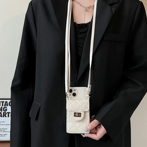 Detail of beige quilted leather phone wallet case with metal lock and crossbody strap