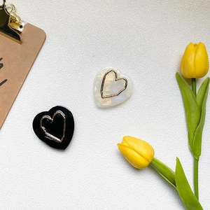 Minimalist heart-shaped phone grip stand in black and marble white with gold outline