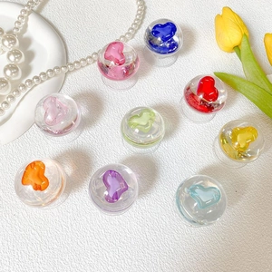 Close-up of assorted colorful crystal heart phone grip accessories on a white surface