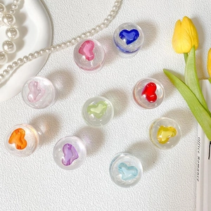 Macro detail of nine colorful 3D heart charms inside transparent resin phone grips