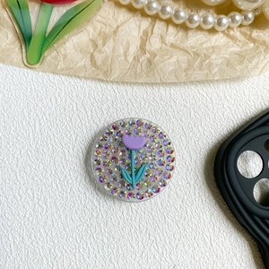Detailed view of rhinestone tulip phone grip with sparkling crystals and purple floral design