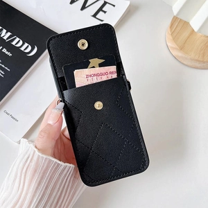 Detail of black cross-grain leather phone case with dual snap button card slots