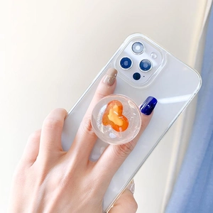Close-up of clear phone case with a 3D airbag stand and orange 3D heart insert