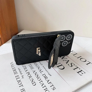 Detail of black quilted leather iPhone case with gold logo and functional hand strap