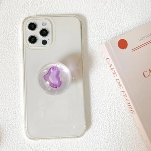 Clear phone case with purple heart-shaped air bag stand on stylish background