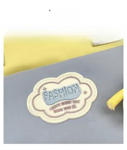 Detailed view of canvas fabric texture and cloud patch on yellow and blue tote bag