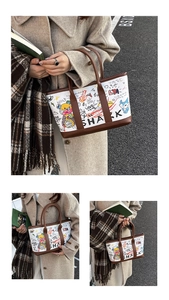 Detailed view of urban graffiti bucket bag with colorful letters and brown leather trim