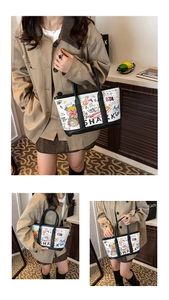 Detail view of white graffiti bucket bag with black handles and colorful shark artwork