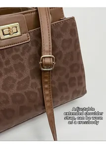 Detail view of leopard print texture with adjustable brown leather shoulder strap
