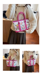 Detail of pink graffiti tote bag featuring cartoon bears and shark prints on white canvas