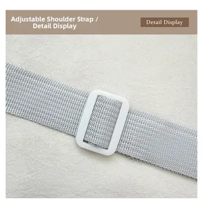 Detail view of adjustable grey woven shoulder strap with white buckle for handbags