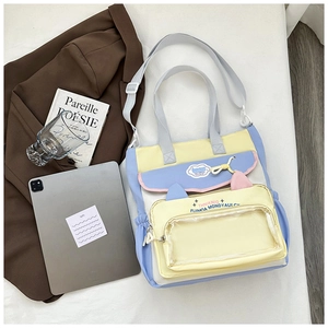 Detail of multi-color tote bag with pink cat ears and transparent PVC display pocket