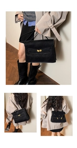 Detail of black matte leather tote bag featuring golden metal turn lock and versatile straps