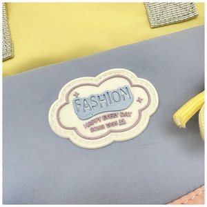 Close-up of fabric texture and colorful patchwork design with cloud-shaped fashion patch
