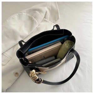 Detail view of large capacity tote bag interior showing space for tablet and books