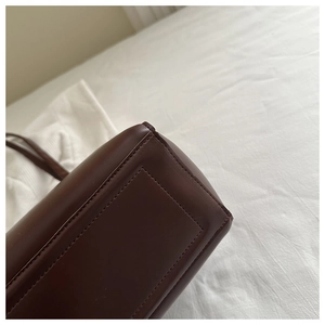 Detailed close-up of stitching and premium dark brown matte leather on large tote bag