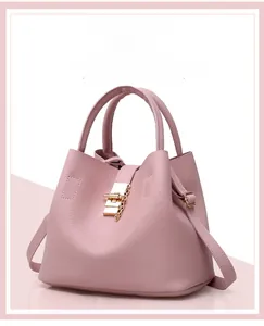 Close-up of pink litchi grain leather bucket bag with gold chain and buckle hardware