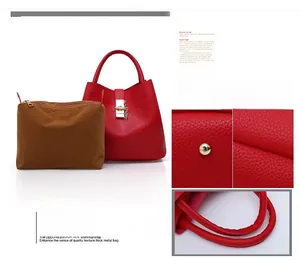 Detail view of red lychee grain leather bucket bag with gold lock and brown inner pouch