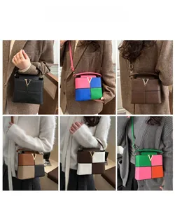 Detailgitter modischer Eimertaschen mit Kontrastfarben und goldenen V-Schnallen