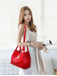 Close-up of red PU leather tote bag featuring gold metal buckle and adjustable shoulder strap