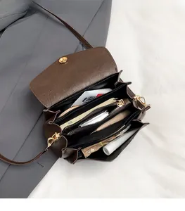 Interior view showing the large capacity and multiple compartments of this brown crossbody bag