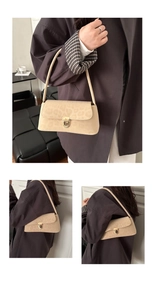 Detail of beige leopard print suede shoulder bag featuring a gold metal twist lock