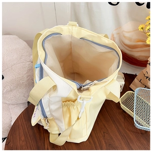 Detail showing the large capacity opening with blue zipper and beige lining of the tote bag