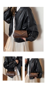 Detail view of vintage dark brown crossbody bag with flap and decorative round button