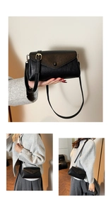 Detail of black vintage crossbody bag with grain leather texture and gold hardware