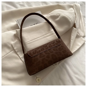Detail of vintage leopard print shoulder bag on stylish white textured background