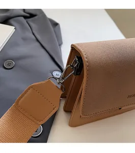 Detailed macro view of the brown leather bag with gunmetal hardware and fashion strap