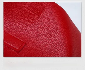 Macro shot showing red pebbled leather material texture with precise stitching detail