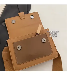 Close-up of brown pebbled leather bag featuring a front pocket with silver magnetic snaps