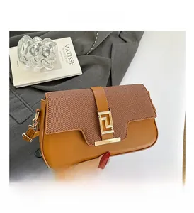 Close-up of tan leather handbag featuring woven texture flap and golden geometric buckle