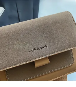 Detailed macro view of brown frosted leather texture and FASHION & BAGS printed logo